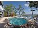 Stunning pool with brick accents and scenic waterfront views, perfect for relaxation and outdoor entertaining at 2407 Avenue A, Bradenton Beach, FL 34217