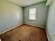 Empty bedroom with carpet and window at 26313 84Th E Ave, Myakka City, FL 34251