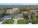 Overhead view of a single-story home with a green lawn, surrounded by mature trees in a residential neighborhood at 3266 Lanai Ave, North Port, FL 34288