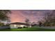 Backyard with a well-maintained lawn and seating area underneath a beautiful sky at 3266 Lanai Ave, North Port, FL 34288