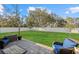 Seating area on a paved patio with a view of a large fenced backyard and lawn at 3266 Lanai Ave, North Port, FL 34288