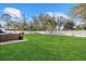 Seating area on a patio with a view of a large fenced backyard and lawn at 3266 Lanai Ave, North Port, FL 34288
