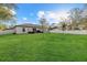 Large backyard with a well-maintained lawn and white fence on a sunny day at 3266 Lanai Ave, North Port, FL 34288