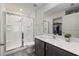 Bright bathroom features a glass shower and a sink with a quartz countertop at 3266 Lanai Ave, North Port, FL 34288