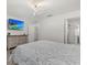 Bedroom featuring an en suite bath, dresser, and television at 3266 Lanai Ave, North Port, FL 34288