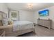 Bright bedroom featuring wood-look floors, a large window, and a wall-mounted television at 3266 Lanai Ave, North Port, FL 34288