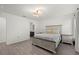 Bedroom with wooden bed frame and nightstands, as well as a view into the bathroom at 3266 Lanai Ave, North Port, FL 34288