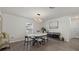 Bright dining room features modern lighting, a table with seating for four, and sleek wood floors at 3266 Lanai Ave, North Port, FL 34288