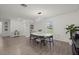 Bright dining room features modern lighting, a table with seating for six, and sleek wood floors at 3266 Lanai Ave, North Port, FL 34288