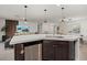 Kitchen island featuring a stainless dishwasher and a view into the living area at 3266 Lanai Ave, North Port, FL 34288