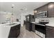 Contemporary kitchen featuring stainless appliances, quartz countertops, and an eat in dining area at 3266 Lanai Ave, North Port, FL 34288