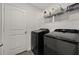 Well-equipped laundry room with modern black washer and dryer appliances at 3266 Lanai Ave, North Port, FL 34288