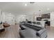 Open-concept living area with bar seating, sleek flooring, a modern sofa, and pendant lighting at 3266 Lanai Ave, North Port, FL 34288