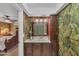 This is a bathroom with a tropical wallpaper, wooden cabinets and white countertop at 3722 Glen Oaks Manor Dr, Sarasota, FL 34232