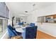 Bright dining area with a window and blue accent chairs, adjacent to the kitchen and living space at 3758 59Th W Ave # 4099, Bradenton, FL 34210