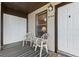 Front entryway with covered porch, white door, and neutral-toned seating area at 3758 59Th W Ave # 4099, Bradenton, FL 34210