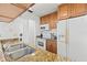 A well-lit kitchen with white appliances, wood cabinets and granite counters at 3758 59Th W Ave # 4099, Bradenton, FL 34210