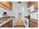Kitchen area with wood cabinets and granite countertops leads to another room at 3758 59Th W Ave # 4099, Bradenton, FL 34210