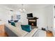 Bright living room with a decorative fireplace, plush sofa, and ample natural light at 3758 59Th W Ave # 4099, Bradenton, FL 34210