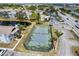 Aerial view of the tennis court in a community near a pond at 3758 59Th W Ave # 4099, Bradenton, FL 34210