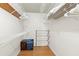 Spacious walk-in closet with wooden floors, with ventilated shelving and racks for storage at 3758 59Th W Ave # 4099, Bradenton, FL 34210