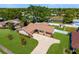 An aerial view of a single-story home with a spacious lawn, mature trees, and a long driveway at 3802 24Th W Ave, Bradenton, FL 34205