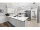 Kitchen area featuring stainless steel appliances, white cabinets, light countertops, and wood flooring at 3802 24Th W Ave, Bradenton, FL 34205