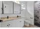 Bathroom featuring dual sink vanity with modern fixtures and tiled shower at 3807 Las Vegas Ave, North Port, FL 34288