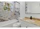 Modern bathroom featuring marble tile, new fixtures, and a tub at 3807 Las Vegas Ave, North Port, FL 34288