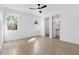 Bright bedroom features tile floors, a ceiling fan and ensuite bathroom at 3807 Las Vegas Ave, North Port, FL 34288