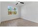 Bedroom with tile floors, ceiling fan and a large window at 3807 Las Vegas Ave, North Port, FL 34288