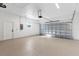 Spacious garage featuring an epoxy floor, bright lighting, and new garage door at 3807 Las Vegas Ave, North Port, FL 34288