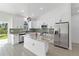 Bright, open kitchen with stainless steel appliances, a spacious island, and ample counter space for cooking at 3807 Las Vegas Ave, North Port, FL 34288