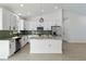 A modern kitchen featuring stainless steel appliances, a stylish island, and sleek white cabinetry at 3807 Las Vegas Ave, North Port, FL 34288