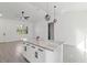 Bright kitchen with white cabinets, modern fixtures and gray tile floors at 3807 Las Vegas Ave, North Port, FL 34288