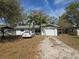 Charming single-story home with a one-car garage, a gravel driveway, and mature landscaping at 3855 43Rd N Ter, St Petersburg, FL 33714