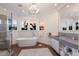 Luxurious bathroom with a soaking tub, modern fixtures, and natural light at 3916 N Shell Rd, Sarasota, FL 34242