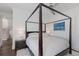 Bedroom with a four-poster bed, bright sconces, and stylish bedside table at 3916 N Shell Rd, Sarasota, FL 34242
