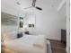 Comfortable bedroom with plush bedding, hardwood floors, and plenty of natural light at 3916 N Shell Rd, Sarasota, FL 34242