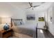 Comfortable bedroom with sleek ceiling fan, stylish decor, and natural light from the window at 3916 N Shell Rd, Sarasota, FL 34242