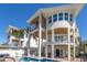 Modern architecture showcases a multi-story home with a pool, balconies, and spacious outdoor living areas at 3916 N Shell Rd, Sarasota, FL 34242