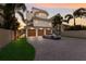 Beautiful modern home with three-car garage, well-manicured lawn, lush palm trees, and elegant architectural details at 3916 N Shell Rd, Sarasota, FL 34242