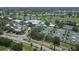 Aerial view showcases the sprawling community with a golf course, tennis courts, pools, and lush greenery at 404 Cerromar N Cir # 119, Venice, FL 34293