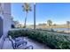 Balcony overlooking waterfront views and lush landscaping, creating a peaceful outdoor retreat at 404 Cerromar N Cir # 119, Venice, FL 34293