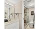 Bathroom featuring a glass-enclosed shower, white vanity, and modern fixtures at 404 Cerromar N Cir # 119, Venice, FL 34293