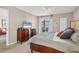 Inviting primary bedroom with a king bed, dresser, and view of the lanai at 404 Cerromar N Cir # 119, Venice, FL 34293