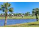 Picturesque golf course view featuring a tranquil lake and vibrant greenery, offering scenic beauty at 404 Cerromar N Cir # 119, Venice, FL 34293