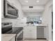 Beautiful kitchen with stainless steel appliances and marble countertop, open to living spaces at 404 Cerromar N Cir # 119, Venice, FL 34293