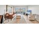Bright living room featuring a comfortable brown leather sofa and sliding doors to the lanai at 404 Cerromar N Cir # 119, Venice, FL 34293