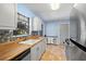 Bright kitchen with butcher block countertops and stainless steel refrigerator at 4062 Blitzen Ter, North Port, FL 34287